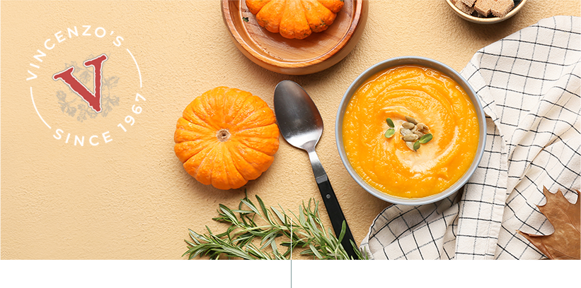 Bowl of tasty pumpkin cream soup on beige background
